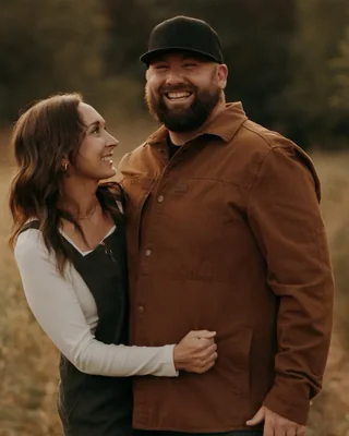 Adam and Bekah Marshall before treatment, smiling together in a field
